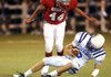 Springdale George’s Kyle Rill sacks Rogers High quarterback Max Harrell during the first half Sept. 30 in Jarrell Williams Bulldog Stadium in Springdale.