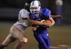 Fayetteville Woodland’s Tres Tucker is tackled by Bentonville Gold’s Chance Pickering on Sept. 30 in Fayetteville.