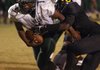 Mills running back Christian Hampton (1) breaks a tackle by Watson Chapel’s Cedric Burnett to score a third quarter touchdown.
