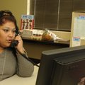  Marisol Ardon, call specialist with United Way 211, answers the phone Friday at the United Way offi...