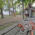 Marty Powers, caretaker for the Shiloh Museum in Springdale, gets a chain saw and ropes ready Monday...