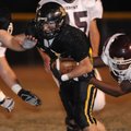 Gentry defensive end Tre’ Asencio-Porter, right, attempts to tackle Prairie Grove’s Weston Bartholom...