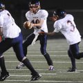 Rogers Heritage’s Josh Qualls hands off the ball to Carlos Hernandez during the freshman game agains...