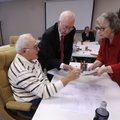 Paul Vinson, left, Truman Yancey and Sallie Hill look over absentee and write-in ballots Wednesday a...