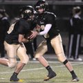  Bentonville Gold’s Jake Slocum, right, hands off to running back J.D. Speed on Thursday against Rog...