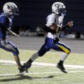 Springdale Central quarterback Kyle Pianalto outruns Rogers High’s Droven Scott to score a touchdow...