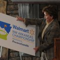  Susan Chambers, executive vice president of global people at Walmart, shows the new logo and name o...