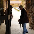  Doreen Lubeck greets Adam Schweizer at the door of Bella Vista Lutheran Church on Tuesday. Schweize...