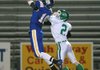 North Little Rock’s Dalton Dunlap (10) catches a touchdown pass in the end zone against Van Buren’s Cole Plunkett (2) during the Charging Wildcats’ 63-21 victory Friday in North Little Rock. 