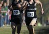 Bentonville’s Will Aenchbacher (right) runs ahead of Little Rock Central’s Jerry Melnyk at the end of the boys’ Class 7A state cross country championship race on Saturday in Rogers. 