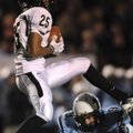 Bentonville wide receiver Desmond Smith hauls in a pass over Springdale Har-Ber defender Riley Gibso...