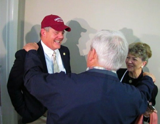 arez-ceo-john-smith-left-wears-a-crossett-hat-as-he-talks-with-local-residents-monday-after-a-news-conference-announcing-a-new-plant-in-the-city