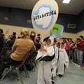 Nate Saferite leads the Antarctica delegation, dressed as penguins, during the Parade of Continents ...