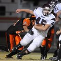Gentry’s Eathen Ramsey escapes from Gravette linebacker Glenn Overturf, left, on Oct. 1 while tight ...