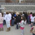 Rex Hickox with the Veterans Council of Northwest Arkansas, talks Thursday with kindergarten student...