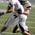 Shiloh Christian senior linebacker Jacob Coffman tackles Greenwood junior wide receiver Derek Morgan...
