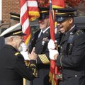 SERVING WITH A SMILE - Paul Dolle of Rogers, center, waves Thursday from the passenger seat of his W...