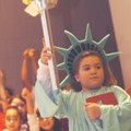 Allison Vaughn, a second-grader at Grimes Elementary School in Rogers, plays the Statue of Liberty d...