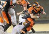 Gravette running back Darrick Strzelecki fights to break away from a Trumann defender Friday during the Lions’ first-round game in the Class 4A state playoffs at Gravette.
