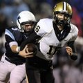 Little Rock Central quarterback Cole Westbrook is sacked by Springdale Har-Ber’s Preston Pianalto du...