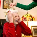 Bicki Carter (right) of Baton Rouge adjusts a crown for her mother, Sarah Yawn, at Yawn’s birthday p...