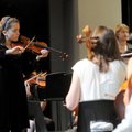 IN TUNE - Washington Junior High School student Mary Moreno, 13, plays a note Saturday to tune the o...