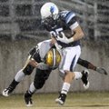 Springdale Har-Ber running back Tucker Lee is hit by Little Rock Central linebacker Larry Wilbourn a...