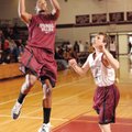 Springdale junior Jarvis Odems, left, scores as sophomore Jordan Johnson, right, defends during the ...