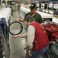 FILE - In this Jan. 28, 2010 file photo, Lowe's employee Hank Fletcher, bottom, shows a washer/dryer...