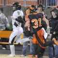 Gravette Lions Tyler Greenhaw drives Trumann Wildcats quaterback Jimmy Creecy to the sidelines at Gr...