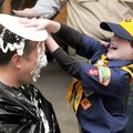 Andrew Maurras, 7, from Rogers Scout Pack 5, takes a different approach by putting the pie on Cubmas...