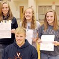 Four Bentonville High athletes celebrated signing college letters of intent Tuesday in Tiger Arena i...