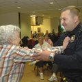 Virginia Griesenauer of Rogers stages a mock attack Tuesday on Bella Vista police officer Terry Dick...