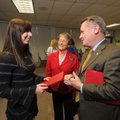 Sarah Howell, left, visits Wednesday with University of Arkansas Chancellor David Gearhart, right, a...