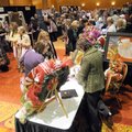  Participants browse through vendor booths Thursday at the Ladies Night Out at the John Q. Hammons C...