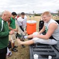  Greenland coach Lee Larkan, left, tapes the ankle of senior Andrew Bray prior to the start of pract...