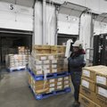  Martinez Clemente wraps up a pallet of turkeys Thursday to send to the Northwest Arkansas Food Bank...