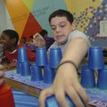  Matthew Self captures a wayward cup during a cup speed-stacking competition Thursday at Helen Tyson...