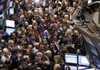Dozens of traders gather near the post where General Motors Co. stock trades Thursday on the floor of the New York Stock Exchange. 