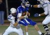Conway quarterback Tyler Langley is sacked by Springdale Har-Ber’s Tucker Lee, left, and Les Harrison early in the first quarter Friday during their second-round game in the Class 7A State Playoffs at Conway.