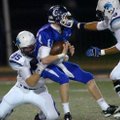  Conway quarterback Tyler Langley is sacked by Springdale Har-Ber’s Tucker Lee, left, and Les Harris...