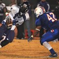  Fayetteville’s Alex Brignoni is tackled by a pair of West Memphis defenders Friday during their sec...