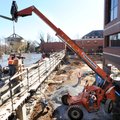  Workers with Lithko Contracting in Tulsa, Okla., pour concrete into forms Friday as work continues ...