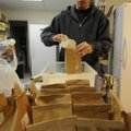 Dax Luningham of Fayetteville bags rice Monday at Cooperative Emergency Outreach in Fayetteville. Lu...
