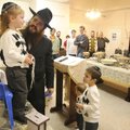 Rabbi Mendel Greisman talks with his son, Mordechai, 3, before the boy’s Upsherin ceremony Nov. 9 in...