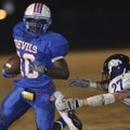 West Memphis running back Quinton Sparkman tries to elude Fayetteville linebacker Cameron Baker on F...