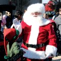 SANTA ARRIVES Santa Claus greets one of his elves upon arrival at Pinnacle Hills Promenade in Rogers...