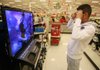 Luis Valdes of Rogers looks over a Panasonic 3-D television last week a the Target store in Rogers. Target is having a four-day, pre-Thanksgiving sale beginning today. 