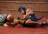 Springdale Har-Ber’s Jaime Garcia, top, tries to pin Springdale High’s Charlie Estrada as referee Gerry Kirk watches on Feb. 2 at Springdale High. Garcia won 15-1.