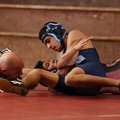 Springdale Har-Ber’s Jaime Garcia, top, tries to pin Springdale High’s Charlie Estrada as referee Ge...